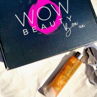 guava and gold shimmering body oil on sand